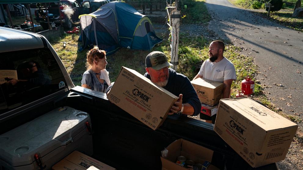 PHOTO: Community members unload relief supplies at Ridgeline Heating and Cooling, which has turned into a relief area and community coordination center in Bills Creek, North Carolina, Oct. 3, 2024, after the passage of Hurricane Helene.