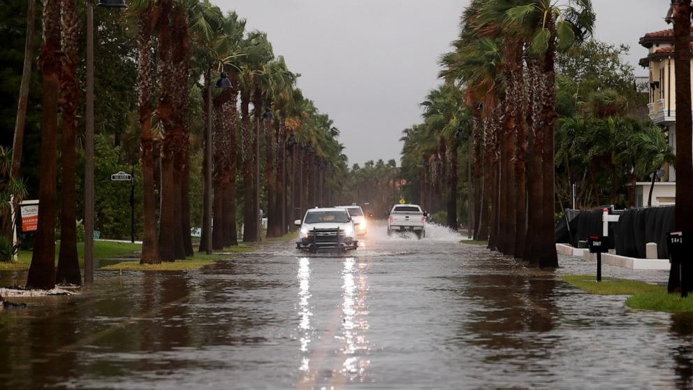 PHOTO: Vehicles drive along a flooded street as Hurricane Helene churns offshore on September 26, 2024, in St. Pete Beach, Florida.