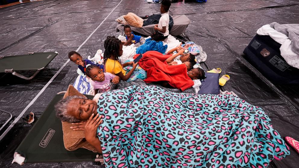 PHOTO: Vera Kelly, of Tallahassee, lies on a cot after evacuating to a hurricane shelter with her grandchildren and great grandchildren, at Fairview Middle School, ahead of Hurricane Helene, in Leon County, Fla., Sept. 26, 2024.