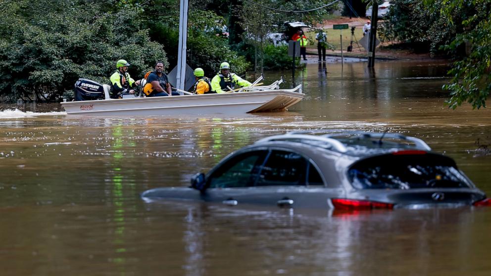 PHOTO: The Atlanta Fire Rescue Swift Water Rescue Team bring Darryl Hall to dry land after his Buckhead neighborhood home was swamped by the flood waters of Peachtree Creek in the aftermath of Tropical Storm Helene in Atlanta, Ga., Sept. 27, 2024.