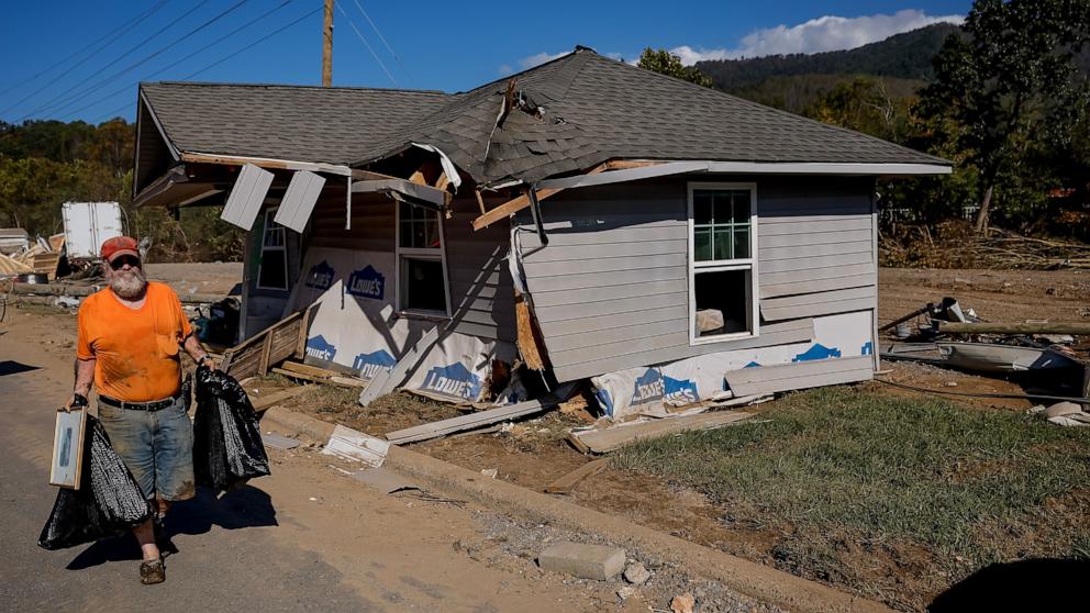 PHOTO: Terry Robinson retrieves personal belongings from his home, which was swept away in the flood in the aftermath of catastrophic flooding caused by Tropical Storm Helene in Swannanoa, NC, Oct. 3, 2024. 