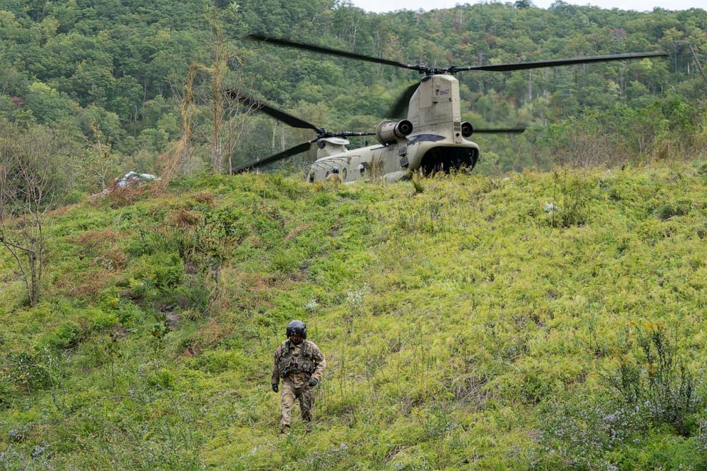 PHOTO: A member of the Maryland National Guard descends a hill at a supply drop point in the aftermath of Hurricane Helene on Oct. 1, 2024, near Bat Cave, N.C.