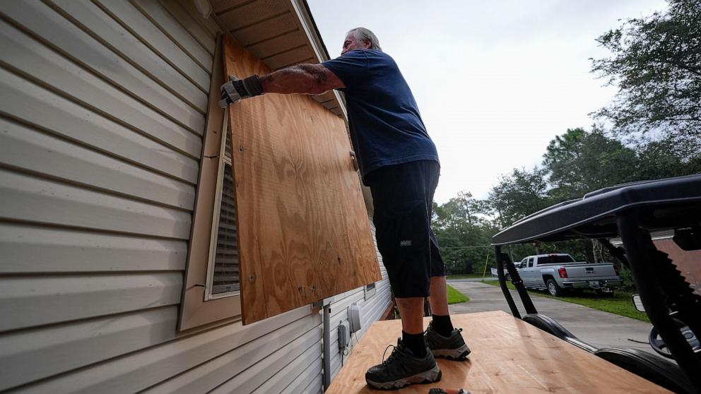 PHOTO: Dave McCurley boards up the windows to his home in advance of Tropical Storm Helene, expected to make landfall as a hurricane, in Ochlockonee Bay, Fla., Sept. 25, 2024.