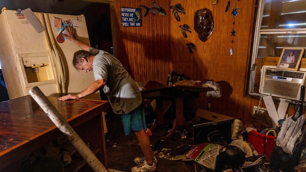 PHOTO: Rex Liberman moves his refrigerator outside before emptying it as he cleans out his house after it was flooded by Hurricane Helene in Steinhatchee, Fla., Sept. 29, 2024.