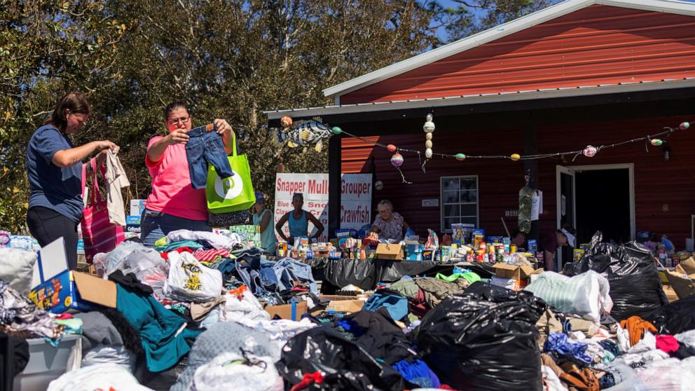 PHOTO: Maddie Hackney, left, and her friend Janie Fowler look for clothing at a donation center organized by Janalea and Garrett England, at their business Steinhatchee Fish Company in the wake of Hurricane Helene in Steinhatchee, Fla., Sept. 29, 2024.