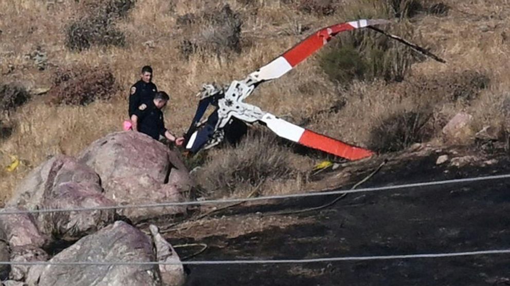 PHOTO: Investigators look at rotor blades from one of the crashed helicopters on a burned hillside in Cabazon, Calif., on Aug. 7, 2023.