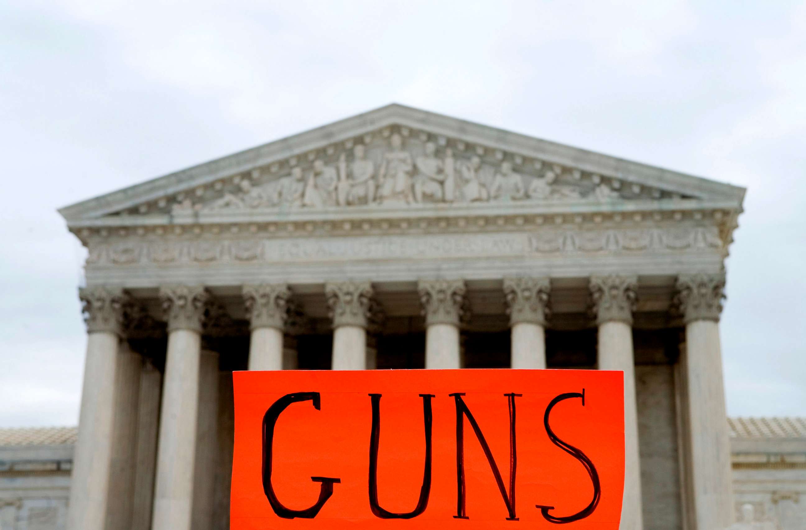 PHOTO: A sign is held up by a protestor outside of the Supreme Court, which was hearing arguments in the gun possession case District of Columbia v. Heller, in Washington, D.C., March 18, 2008.