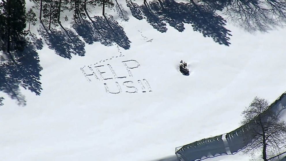 PHOTO: "Help us" can be seen written in the snow near Lake Gregory in San Bernardino County, California, March 3, 2023.