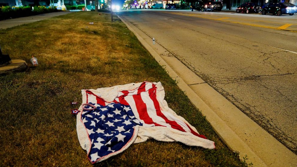 PHOTO: An American flag blanket is seen abandoned along the parade route after a mass shooting at a Fourth of July parade in the Chicago suburb of Highland Park, Illinois, on July 4, 2022.