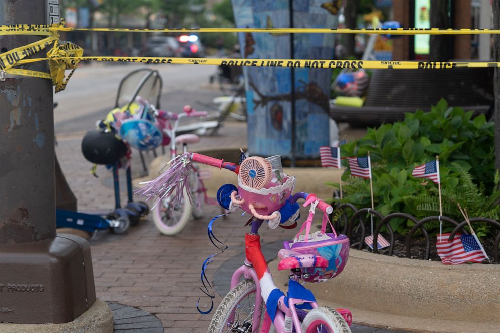 PHOTO: Police crime tape is seen around the area where children's bicycles and baby strollers stand near the scene of the Fourth of July parade shooting in Highland Park, Ill., July 4, 2022.