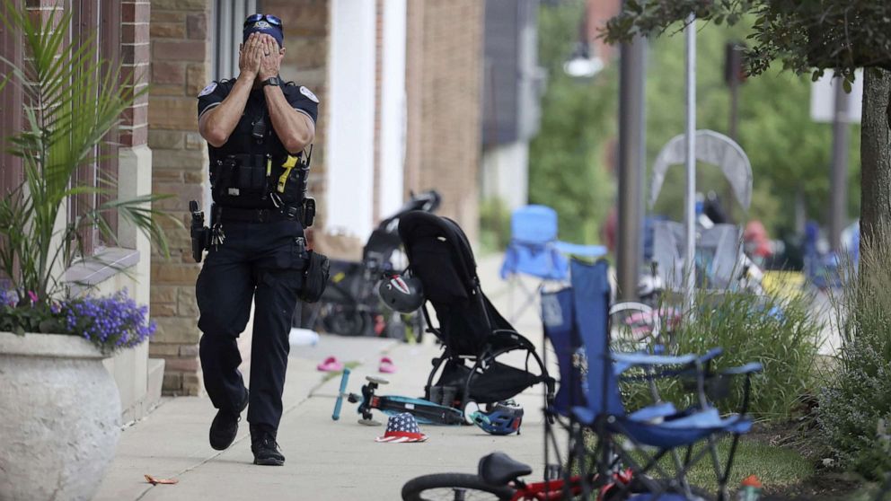 PHOTO: A police officer walks down Central Avenue in Highland Park, July 4, 2022, after a shooter fired on the northern suburb's Fourth of July parade.