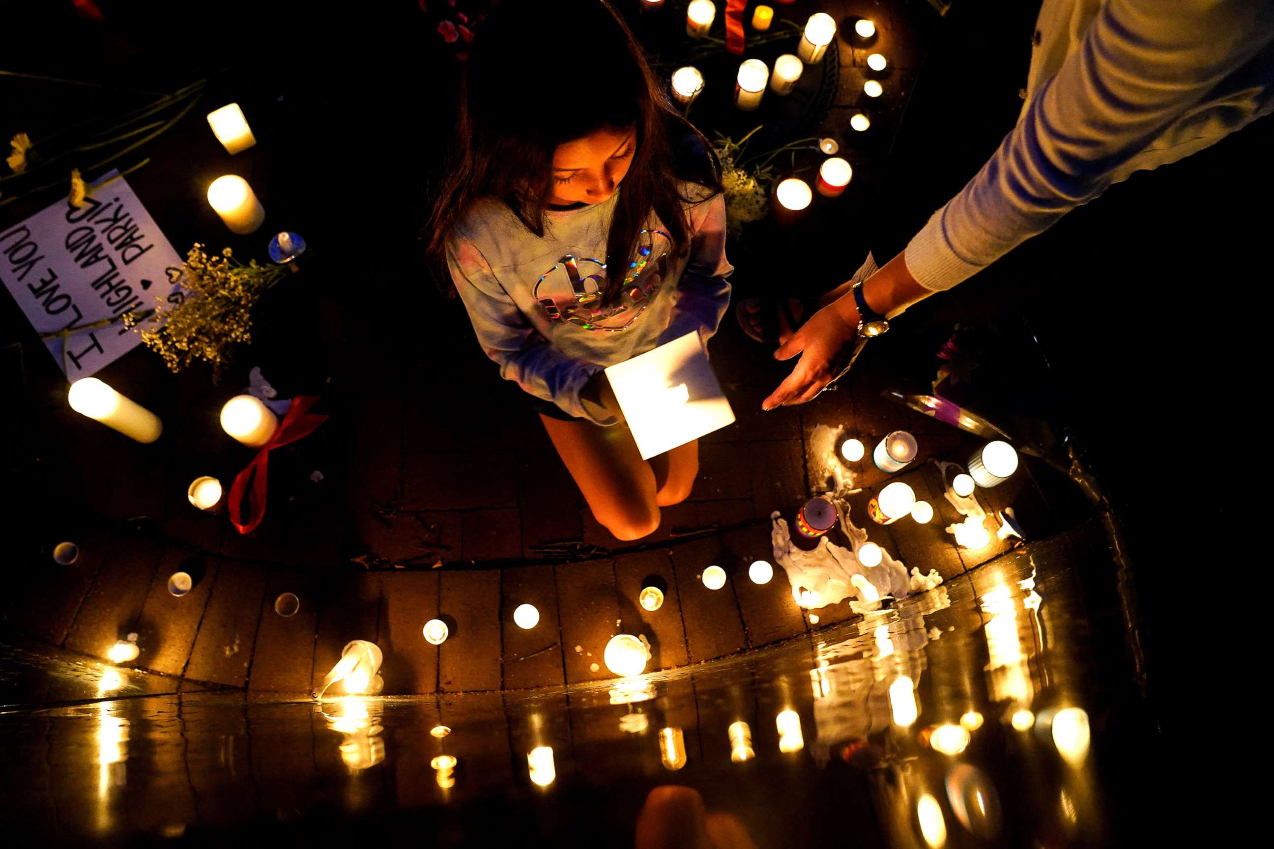 PHOTO: Community members light candles and leave messages at a memorial site near the parade route the day after a mass shooting at a Fourth of July parade in the Chicago suburb of Highland Park, Ill., July 5, 2022.