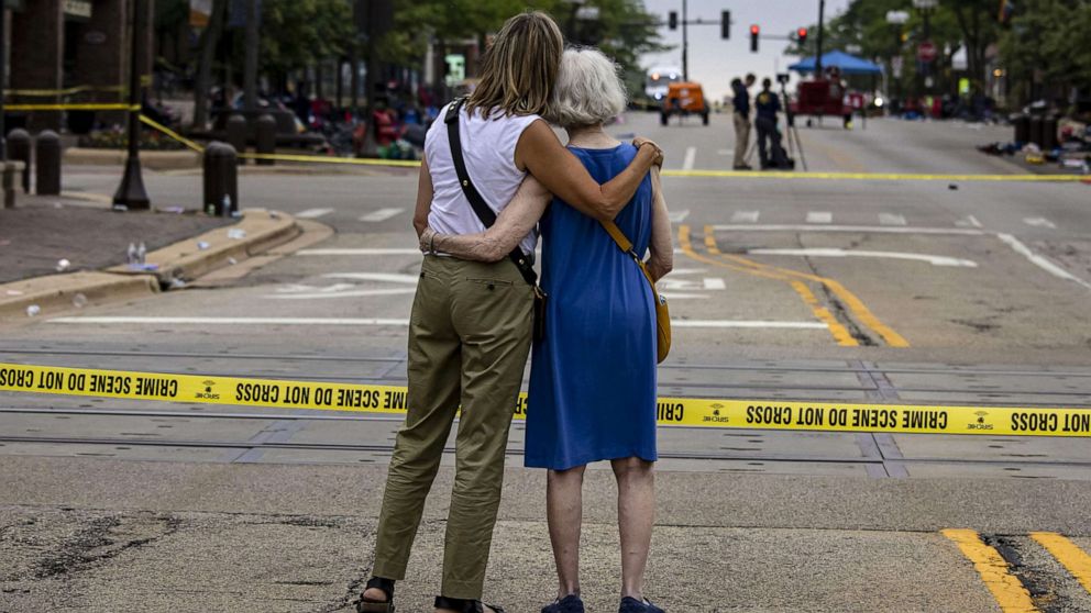 PHOTO: Shana Gutman and her mother Eadie Bear, longtime residents of Highland Park, Illinois, watch the scene on Central Avenue, July 5, 2022, the day after a mass shooting during the July 4 parade.