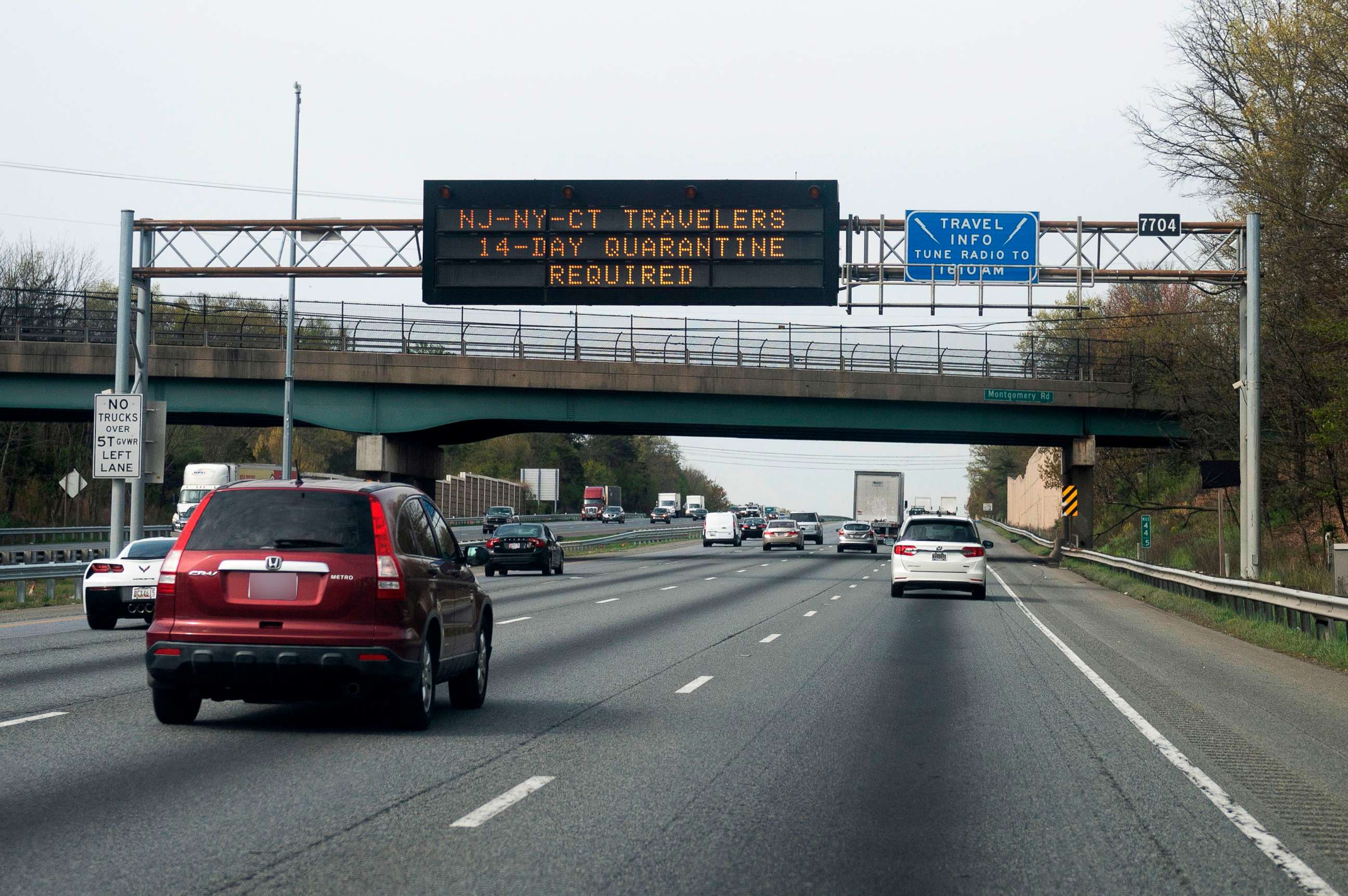 PHOTO: Cars drive below a sign on the highway notifying travelers from New York, New Jersey or Connecticut that they are required to quarantine for 14 days, in Millersville, Maryland, April 17, 2020.