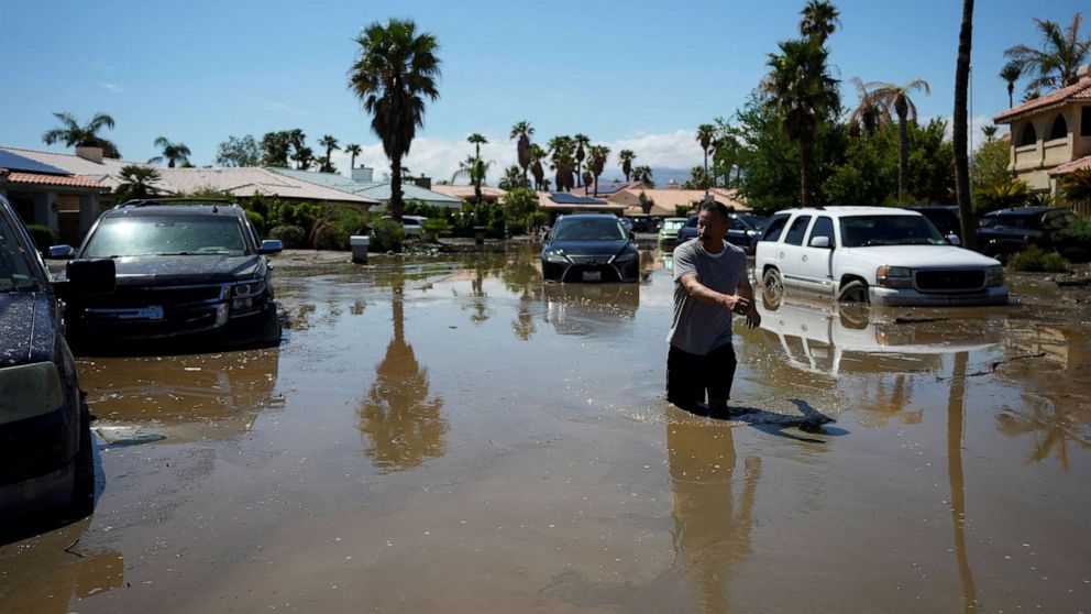 PHOTO: Ronald Mendiola returns his home through a flooded street after Tropical Storm Hilary passed Cathedral City, California, U.S., August 21, 2023. REUTERS/Bryan Woolston?