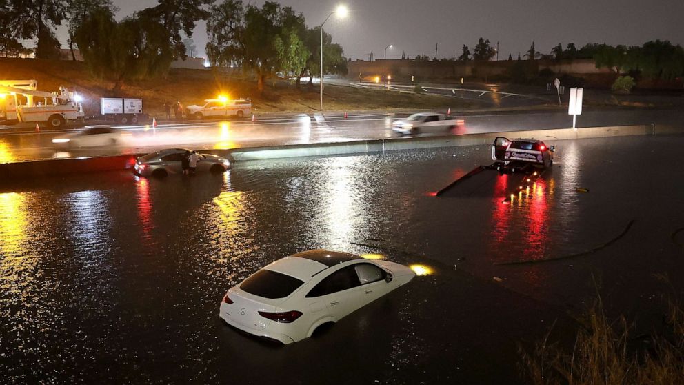 PHOTO: Cars are seen submerged in floodwaters on the Golden State Freeway as tropical storm Hilary moves through the area on Aug. 20, 2023, in Sun Valley, Calif.