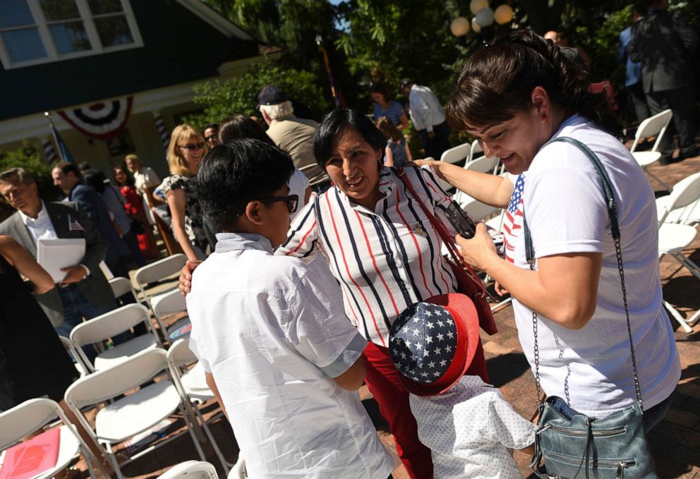 PHOTO: Ana Alania, from Peru, center, meets with family after she became an American citizen during a naturalization ceremony, at Centennial Village Museum, on July 3, 2019, in Greeley, Colo.