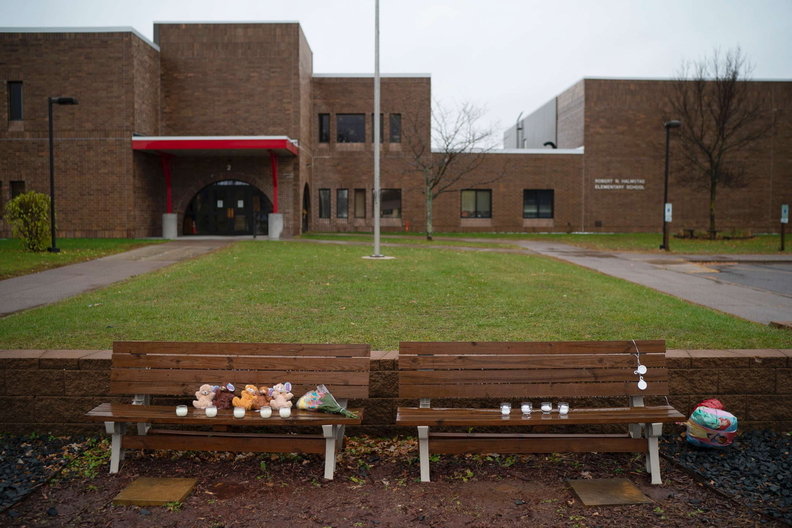 PHOTO: Teddy bears, flowers, and candles were placed on benches outside Halmstad Elementary School in Chippewa Falls, Wis. as a memorial to the three Girl Scouts who were struck and killed by a driver who fled the scene, Nov. 4, 2018.