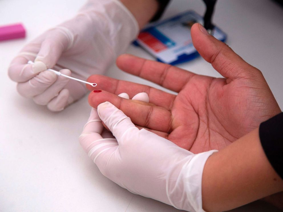 PHOTO: A man undergoes a rapid HIV test during the Gay Pride Parade in Santiago, June 23, 2018.