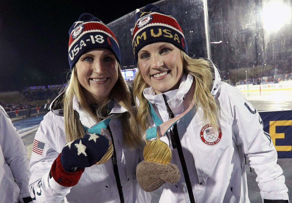 PHOTO: From left, Monique Lamoureux-Morando and Jocelyne Lamoureux-Davidson of the 2018 United States Women's Hockey Team attend a ceremony to acknowledge the team during a hockey game, March 3, 2018, in Annapolis, Md.