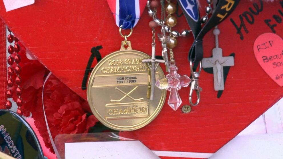 PHOTO: The Marjory Stoneman Douglas High School Eagles hockey team state championship medals are seen decorating memorials dedicated to victims of the mass shooting in Parkland, Fla., Feb. 26, 2018.