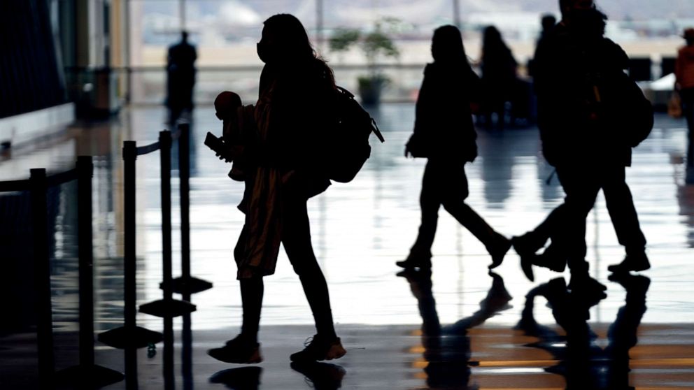 PHOTO: Holiday travelers pass through Salt Lake City International Airport, Dec. 24, 2021, in Salt Lake City.