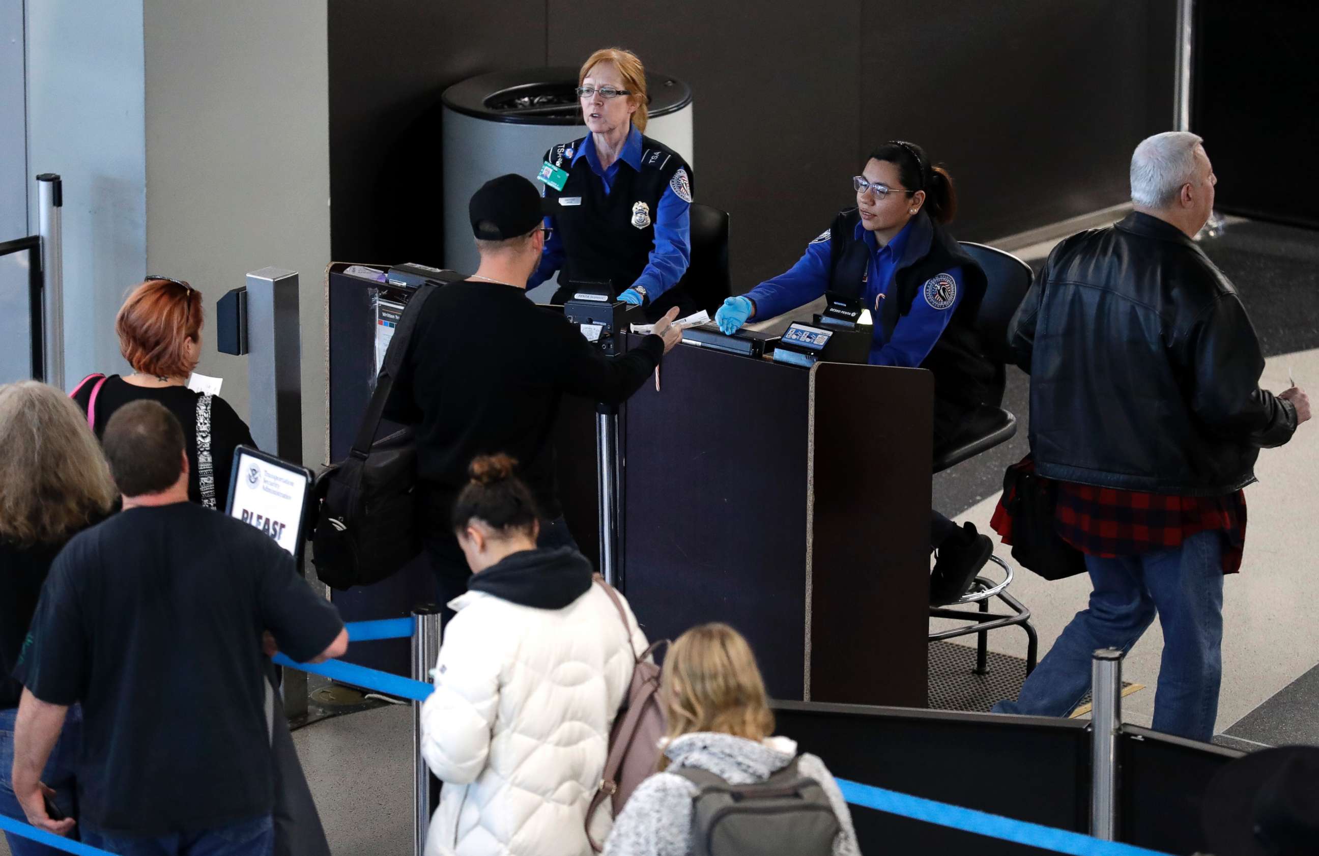 PHOTO: Transportation Security Administration workers screen passengers at O'Hare International Airport, Tuesday, Dec. 25, 2018, in Chicago.