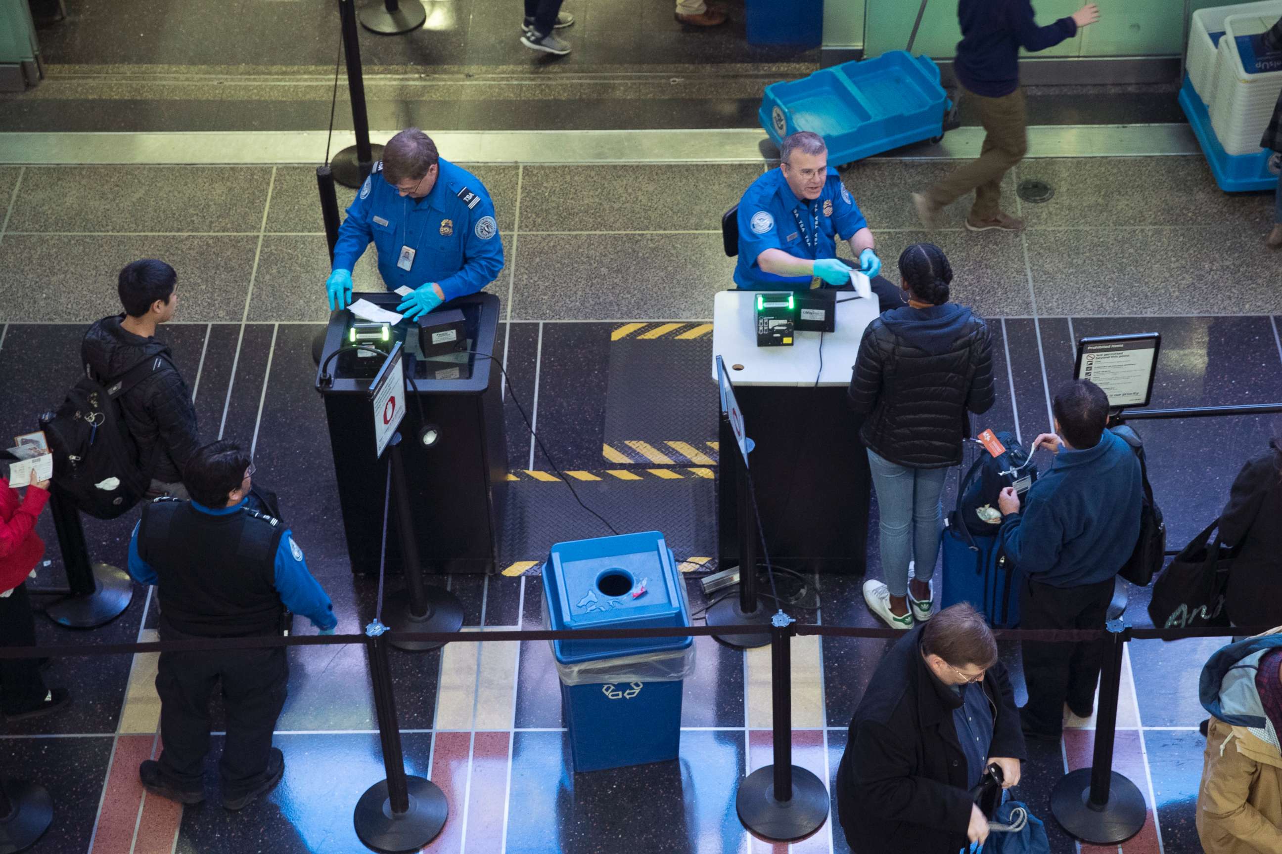 PHOTO: TSA employees checked passenger documents, who were traveling for the Thanksgiving holiday, at Ronald Reagan Washington National Airport in Arlington, Va., November 22, 2017. 