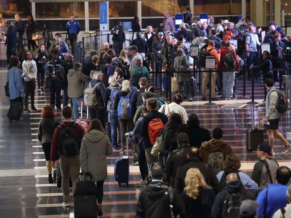 PHOTO: Travelers wait in line to go through the security area at Reagan National Airport on Nov. 21, 2017 in Arlington, Va.