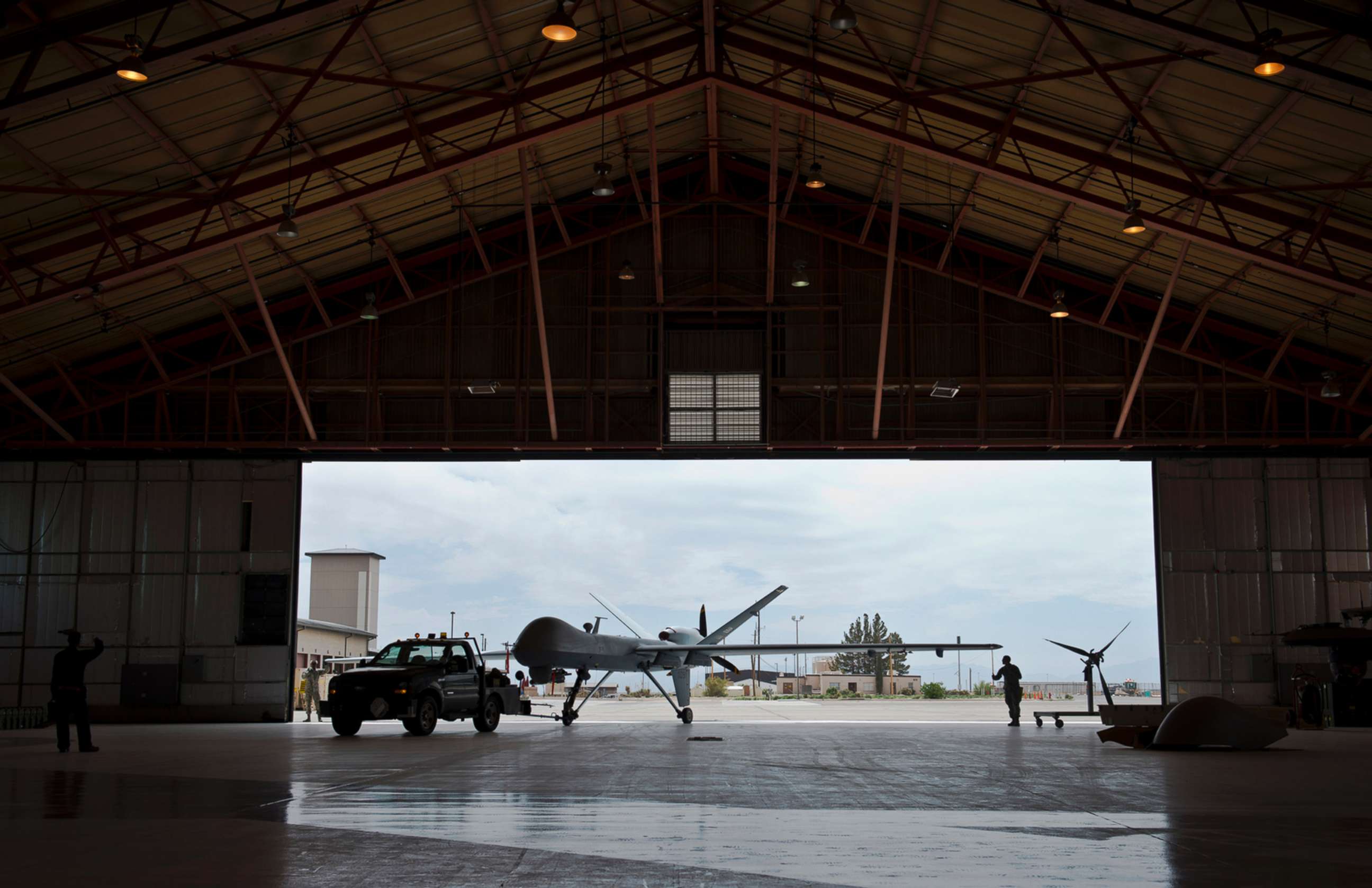 PHOTO: A group of Airmen tow an aircraft into a hangar, April 25, 2013 at Holloman Air Force Base, New Mexico. 