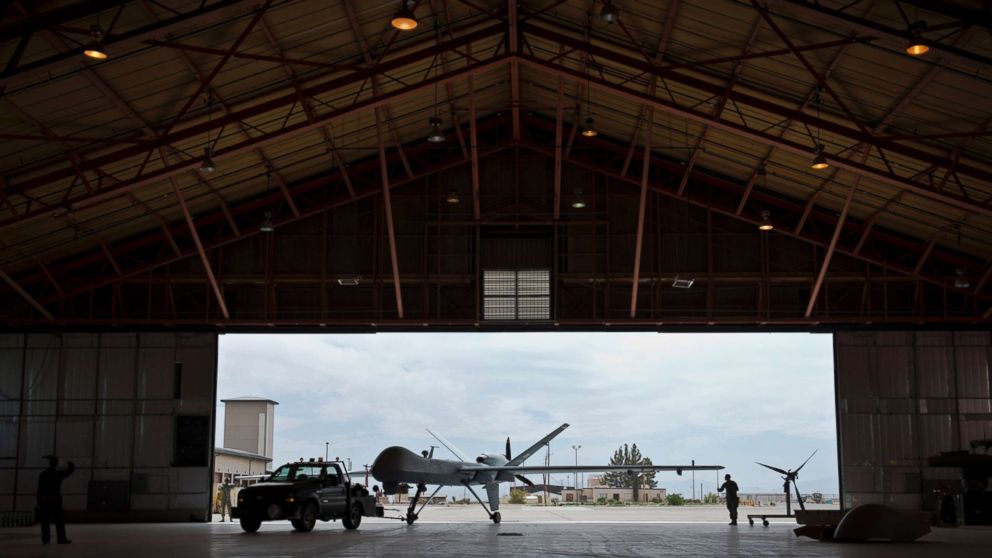 PHOTO: A group of Airmen tow an aircraft into a hangar, April 25, 2013 at Holloman Air Force Base, New Mexico.