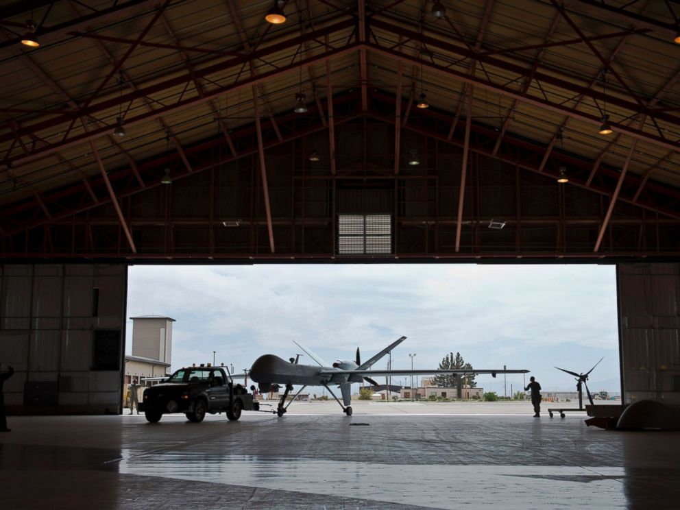 PHOTO: A group of Airmen tow an aircraft into a hangar, April 25, 2013 at Holloman Air Force Base, New Mexico.