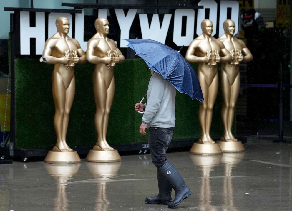 PHOTO: A pedestrian shields himself from strong winds and rain on Hollywood Boulevard during Tropical Storm Hilary, Sunday, Aug. 20, 2023, in Los Angeles.
