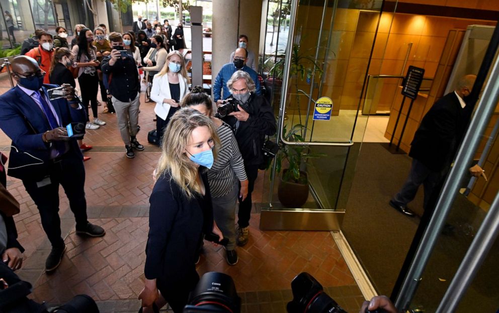 PHOTO: Elizabeth Holmes, bottom center, founder and CEO of Theranos, arrives at the federal courthouse for jury selection in her trial, Aug. 31, 2021, in San Jose, Calif.