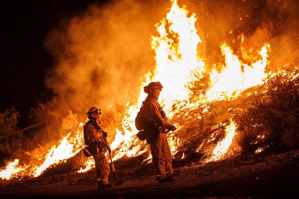 PHOTO: Firefighters conduct a burn operation to remove fuel around homes on Grand Ave as the Holy Fire grows to more than 10,000 acres as the wildfire comes closer to Lake Elsinore, Aug. 10, 2018.