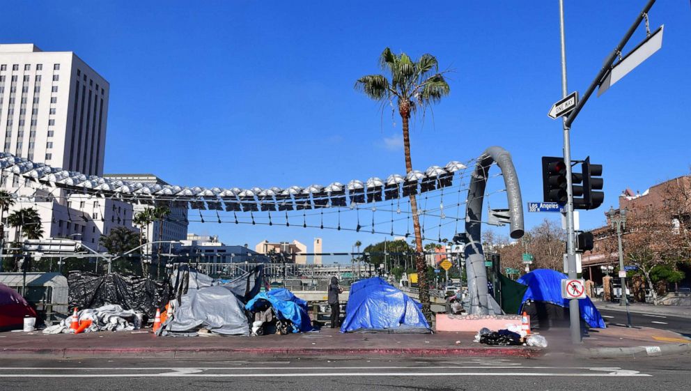 PHOTO:A homeless man stands beside his tent in downtown Los Angeles, Jan. 8, 2020. 