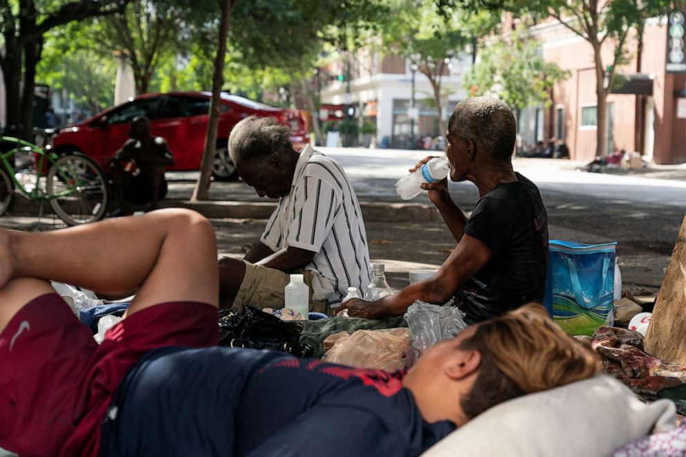 PHOTO: Homeless people rest in the shade in Houston during excessive heat warnings for southeastern Texas on July 16, 2023.