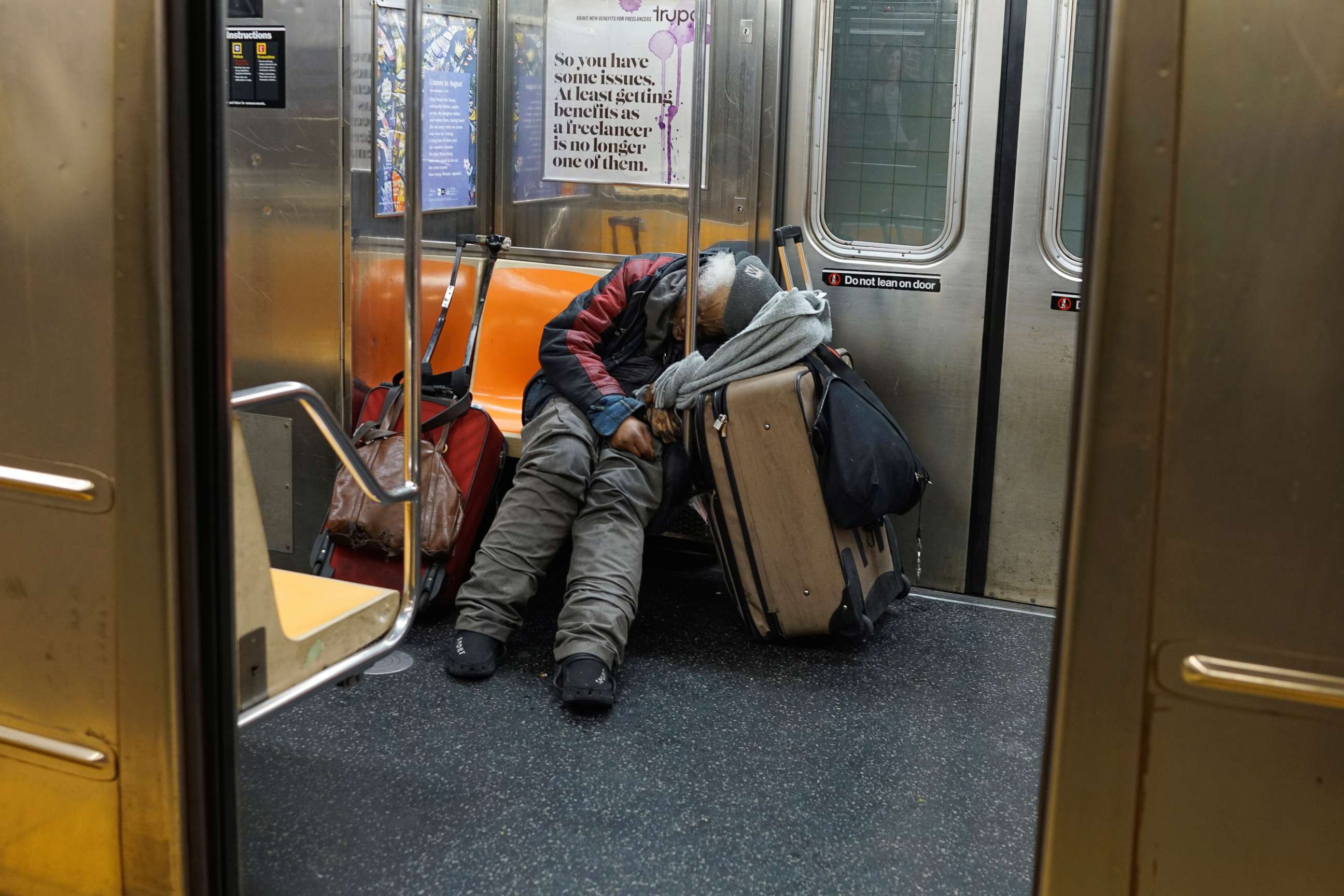 PHOTO: A man sleeps on a New York subway train as the outbreak of the coronavirus continues in New York, April 13, 2020. 