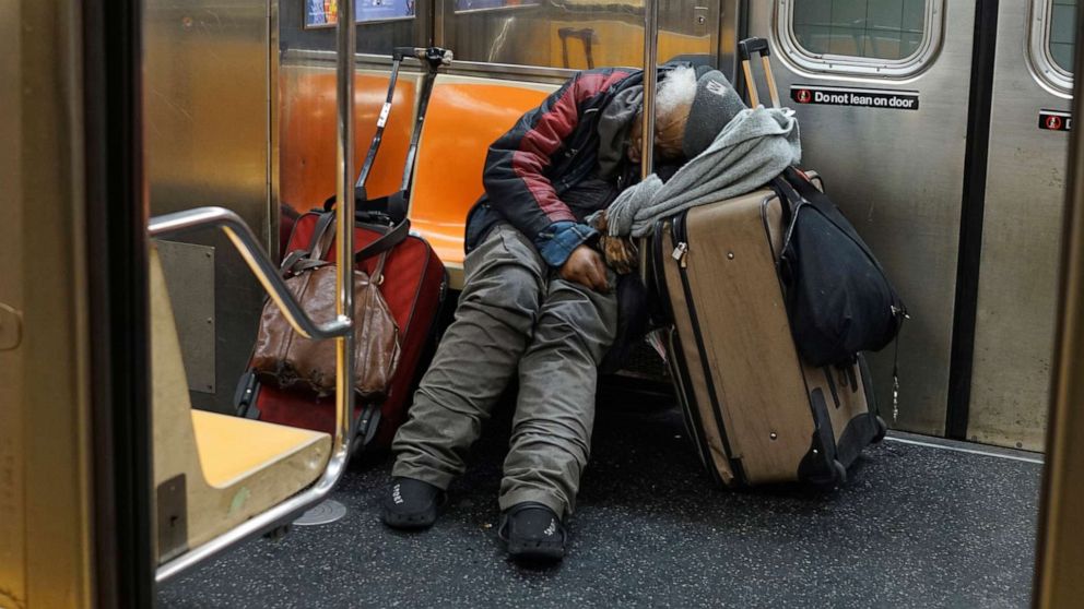 PHOTO: A man sleeps on a New York subway train as the outbreak of the coronavirus continues in New York, April 13, 2020. 