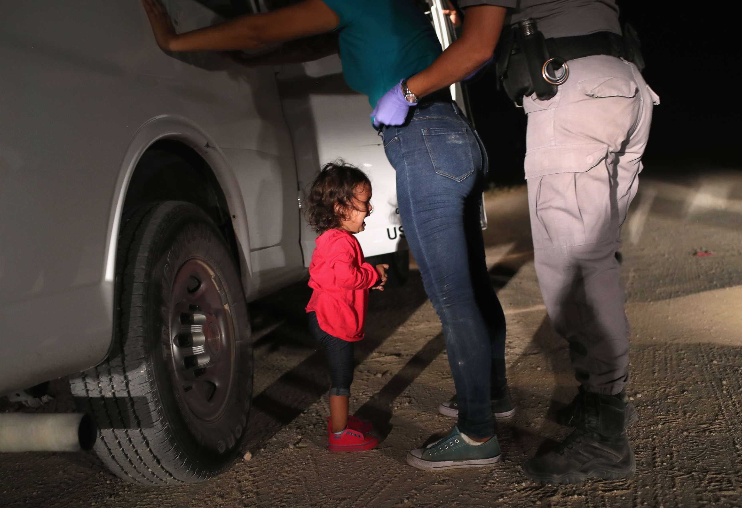 PHOTO: A two-year-old Honduran girl cries as her mother is searched and detained near the U.S.-Mexico border on June 12, 2018 in McAllen, Texas.