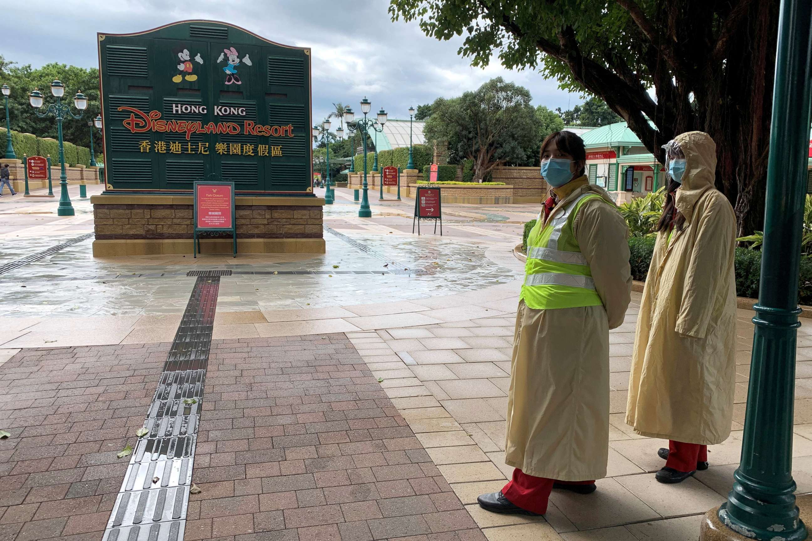 PHOTO: Employees wearing protective masks stand outside the Hong Kong Disneyland theme park that has been closed, following the coronavirus outbreak, in Hong Kong, China January 26, 2020.