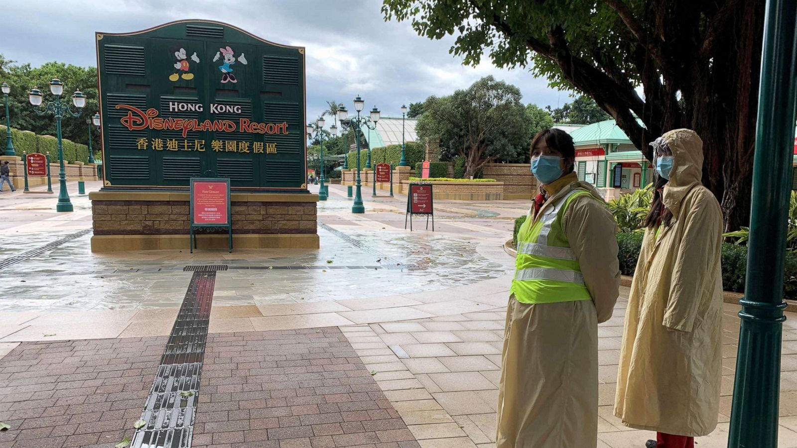 PHOTO: Employees wearing protective masks stand outside the Hong Kong Disneyland theme park that has been closed, following the coronavirus outbreak, in Hong Kong, China January 26, 2020.