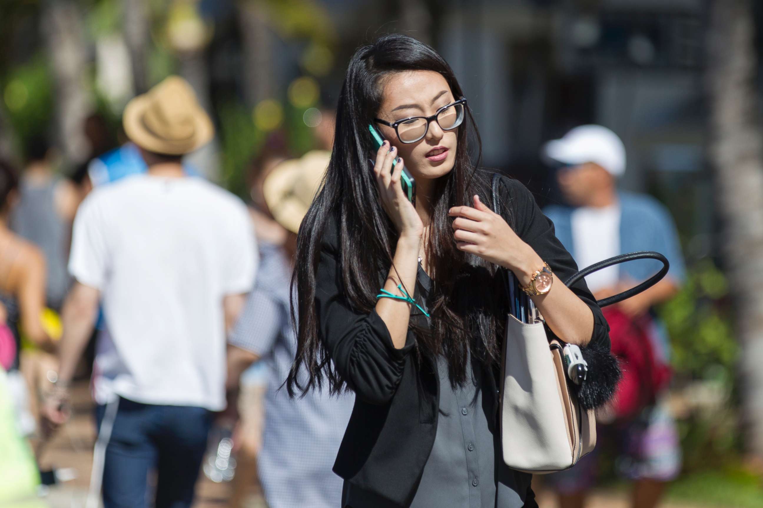 PHOTO: A pedestrian crosses Kalakaua Avenue talking on her cell phone, Oct. 24, 2017 in Honolulu. 