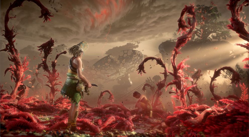 PHOTO: A scene from the trailer for Horizon: Forbidden West shows a character harvesting food from diseased land and looking out at a storm.