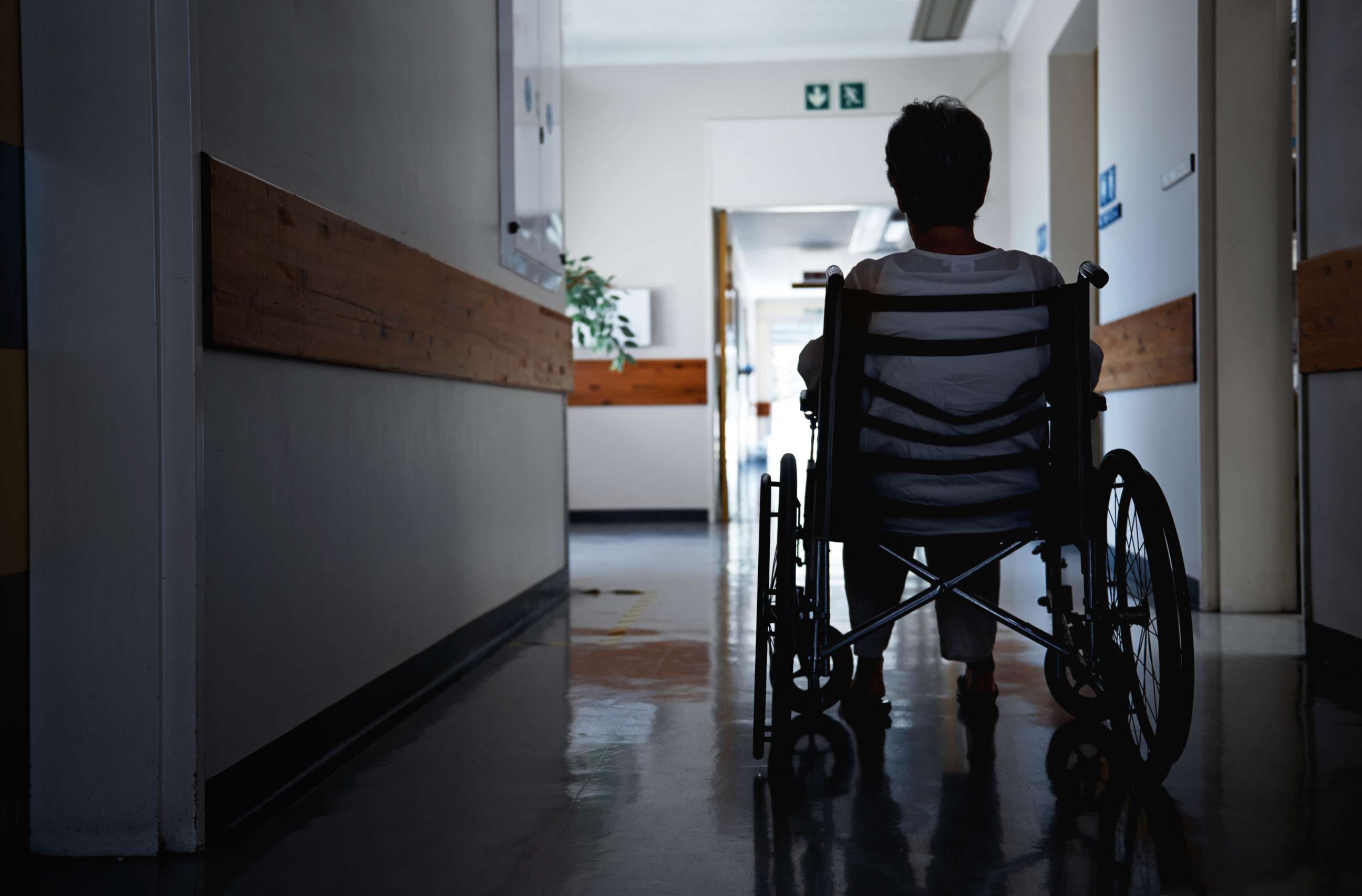 PHOTO: A woman in a wheelchair in what looks like a nursing home. 