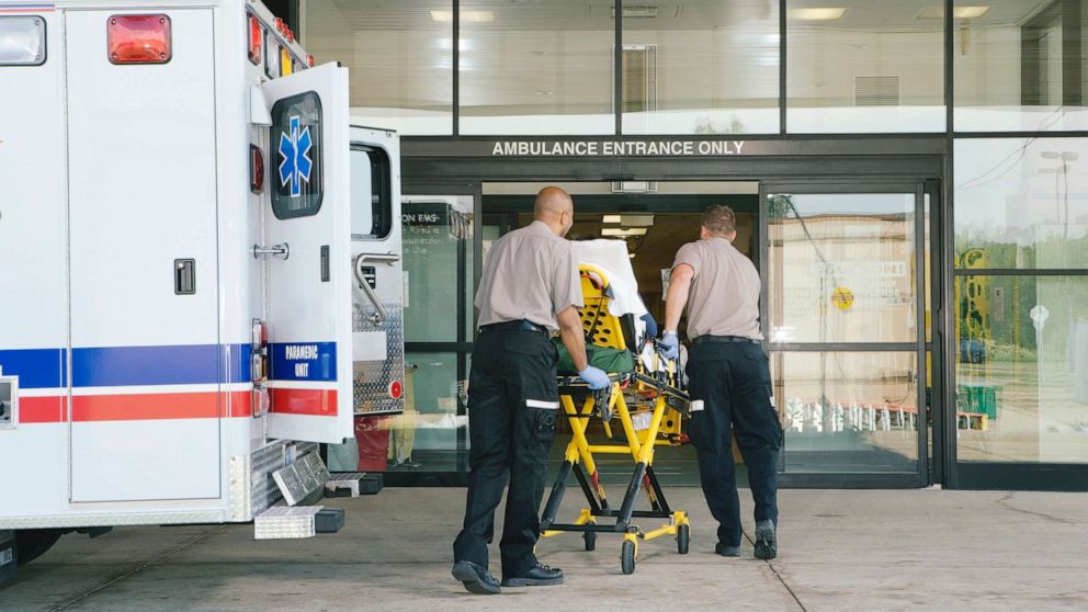 PHOTO: Paramedics take a patient on a stretcher from ambulance to hospital.