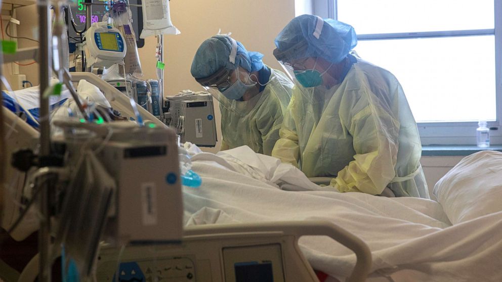 PHOTO: Two nurses assess the vital signs of a COVID-19 patient using a ventilator on the Intensive Care Unit floor at the Veterans Affairs Medical Center, April 21, 2020, in the Brooklyn borough of New York.