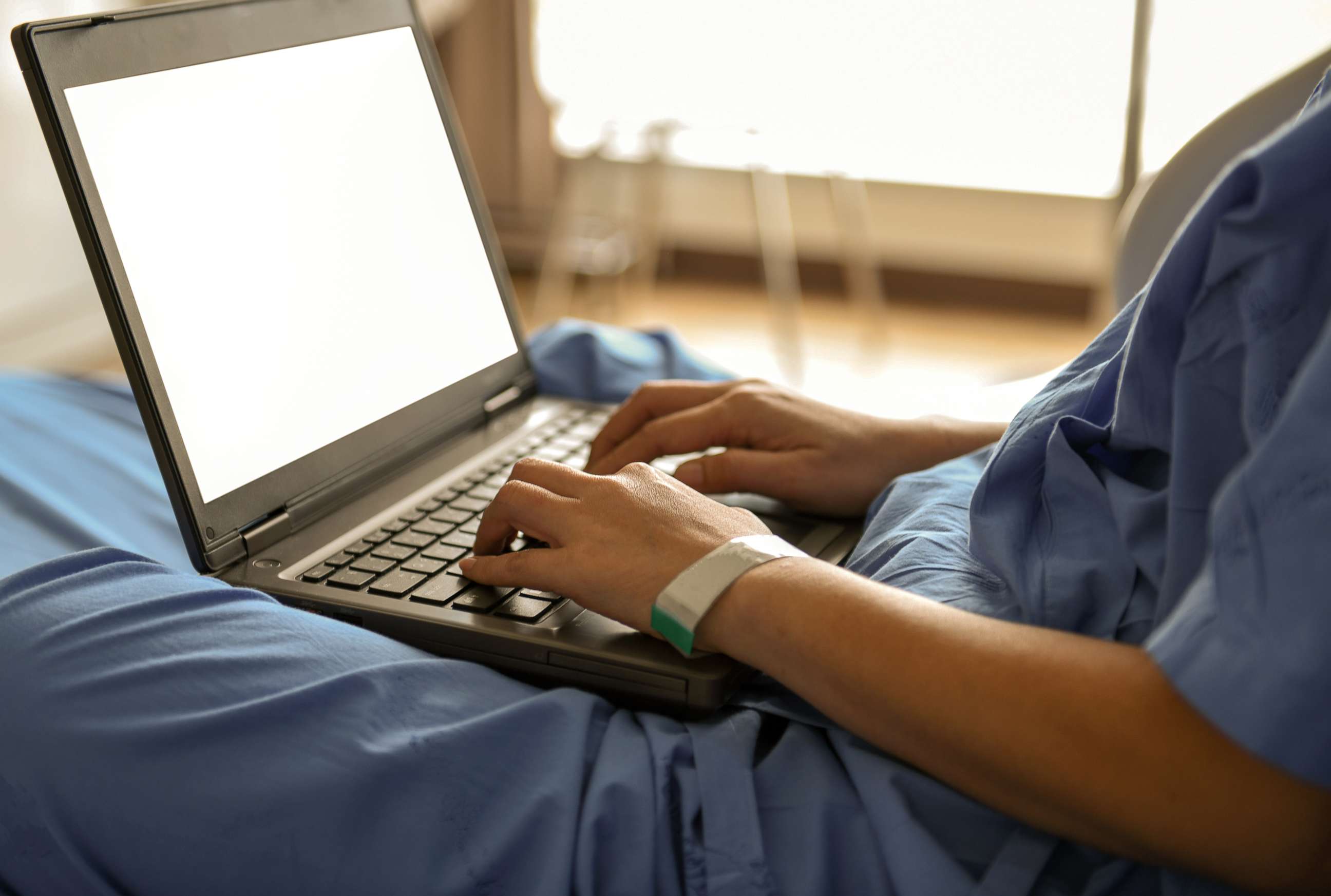 PHOTO: A patient uses a laptop while in the hospital in this stock photo.