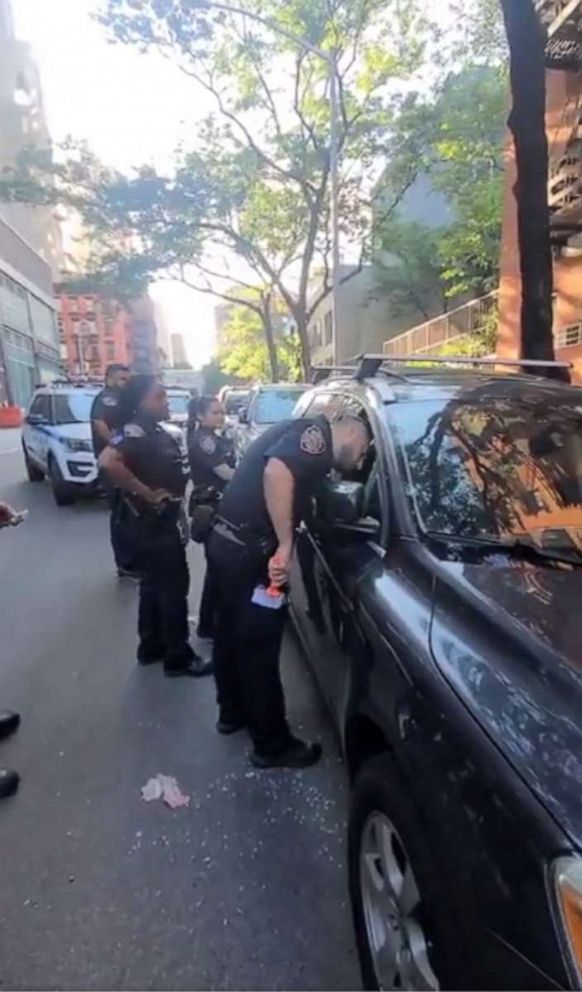 PHOTO: In this screen grab posted to the Twitter account of the NYPD 19th Precinct, police officers are shown rescuing the dog from a hot car after a passerby reported the distressed animal.