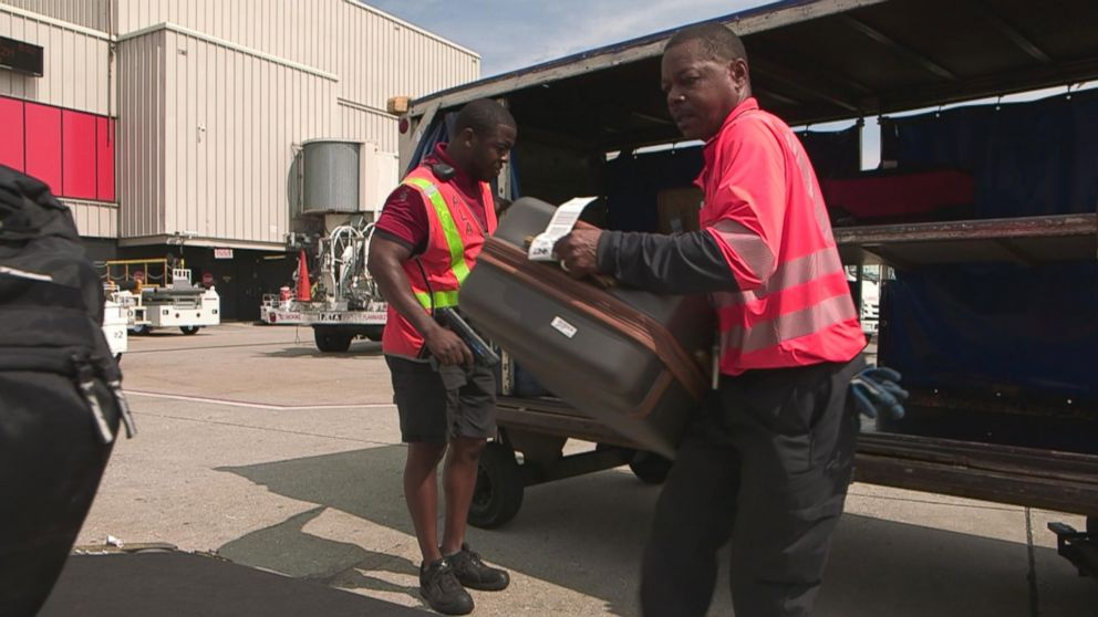PHOTO: If a bag is at risk of missing a connection, it is designated a "hot" bag. Handlers like these find the bags and race them to their next flight.